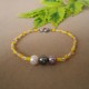 PULSERA EN PEDRERIA TONOS AMARILLOS CON PERLAS